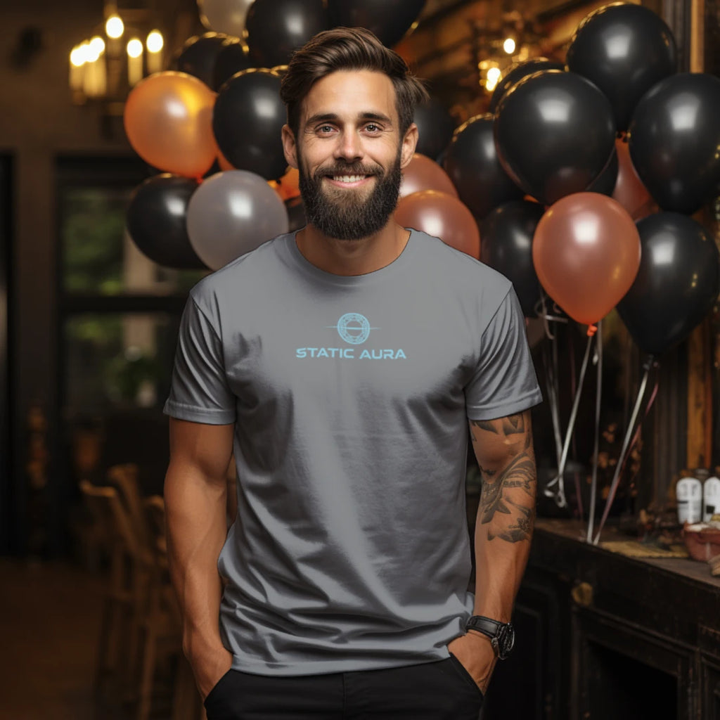 Man wearing a gray t-shirt with 'Static Aura' logo in a festive setting with balloons.